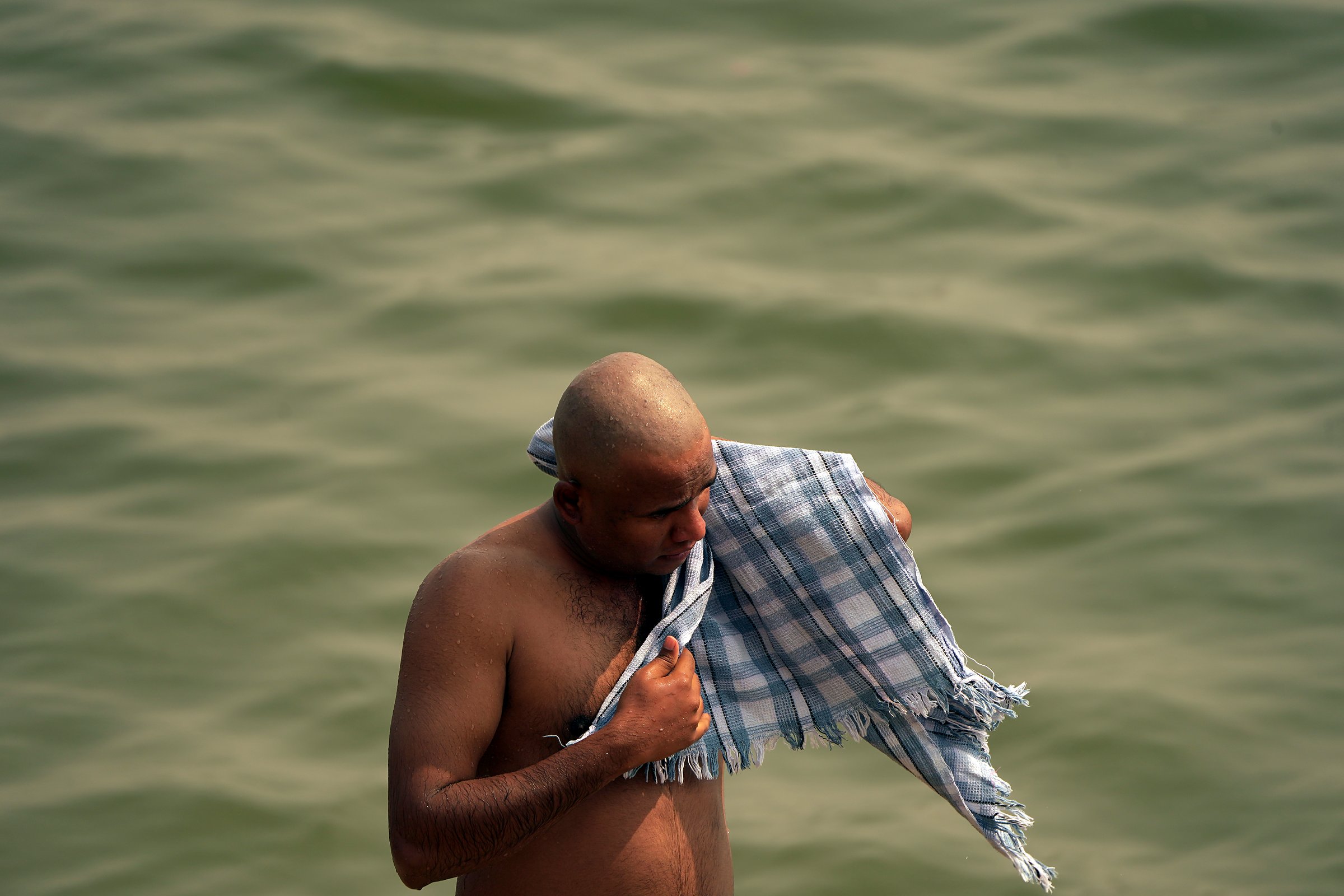 A man bathing in the Ganga at morning